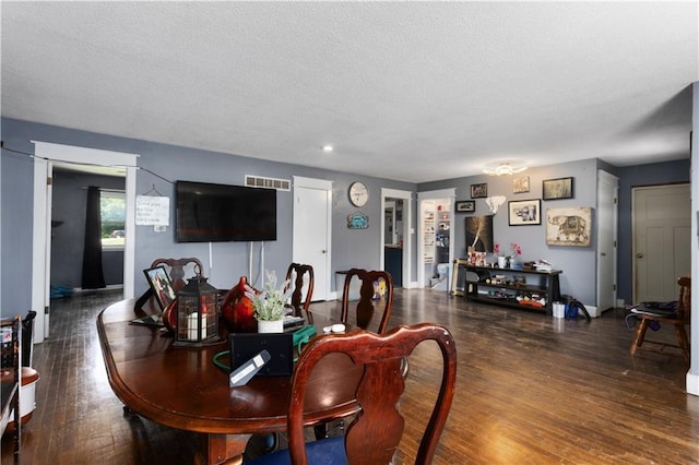 820 S Main St, Lansing, KS 66043 - dining room featuring wood finished floors and a textured ceiling