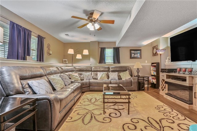 1641 N Hunter Dr, Olathe, KS 66061 - living room with ceiling fan, wood finished floors, and a textured ceiling