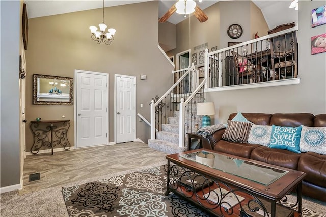 1641 N Hunter Dr, Olathe, KS 66061 - living area featuring high vaulted ceiling, a ceiling fan, a chandelier, stairway, and wood finished floors