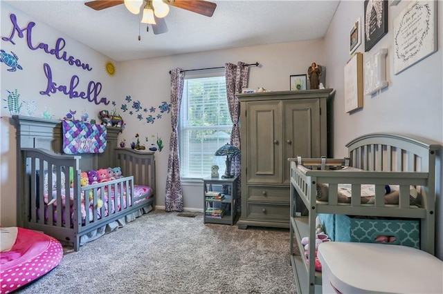 1641 N Hunter Dr, Olathe, KS 66061 - bedroom featuring carpet floors, a textured ceiling, a crib, and a ceiling fan