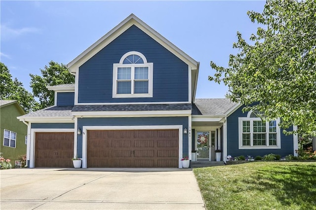 1641 N Hunter Dr, Olathe, KS 66061 - traditional home with a front lawn, roof with shingles, concrete driveway, and an attached garage