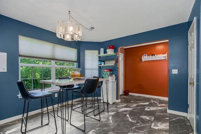 118 SE 215th Rd, Warrensburg, MO 64093 - dining area featuring a chandelier and a textured ceiling