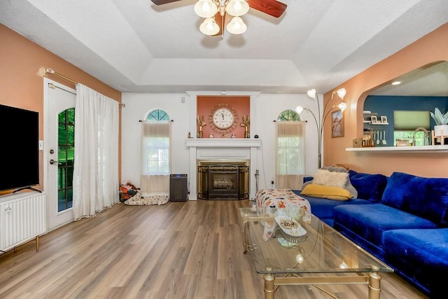 118 SE 215th Rd, Warrensburg, MO 64093 - living room with a raised ceiling, ceiling fan, a fireplace, and wood finished floors