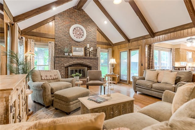 8404 Rosehill Rd, Lenexa, KS 66215 - living area with beamed ceiling, wood finished floors, wood walls, ceiling fan, and a fireplace