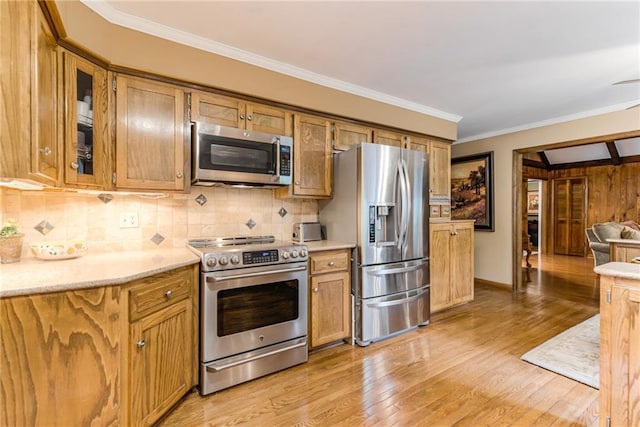 8404 Rosehill Rd, Lenexa, KS 66215 - kitchen featuring appliances with stainless steel finishes, light wood-type flooring, tasteful backsplash, ornamental molding, and glass insert cabinets