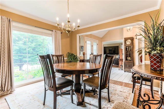 8404 Rosehill Rd, Lenexa, KS 66215 - dining area with a chandelier, plenty of natural light, light wood-style flooring, ornamental molding, and vaulted ceiling