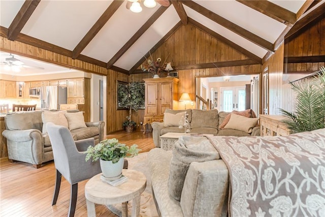 8404 Rosehill Rd, Lenexa, KS 66215 - living room featuring a ceiling fan, wood walls, light wood-type flooring, high vaulted ceiling, and beamed ceiling