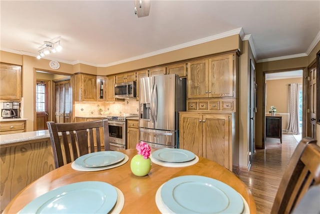 8404 Rosehill Rd, Lenexa, KS 66215 - dining room featuring healthy amount of natural light, crown molding, and wood finished floors
