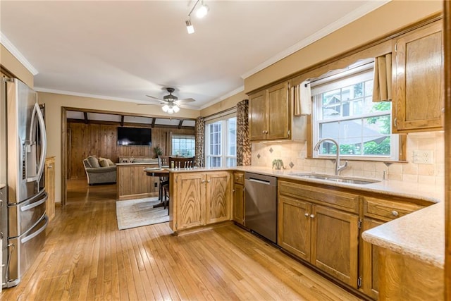 8404 Rosehill Rd, Lenexa, KS 66215 - kitchen featuring stainless steel appliances, a peninsula, light wood-style flooring, a ceiling fan, and tasteful backsplash
