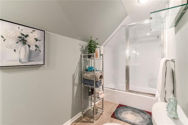 8404 Rosehill Rd, Lenexa, KS 66215 - full bath with wood finished floors, shower / bath combination with glass door, and vaulted ceiling