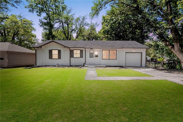 8918 Switzer St, Overland Park, KS 66214 - ranch-style house with concrete driveway, an attached garage, and a front yard
