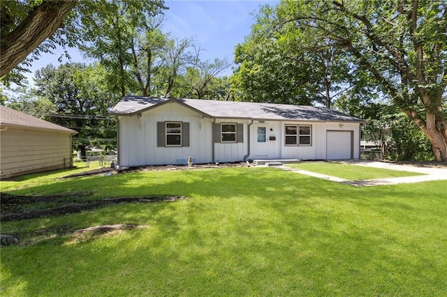 8918 Switzer St, Overland Park, KS 66214 - ranch-style home featuring board and batten siding, driveway, a front lawn, and an attached garage