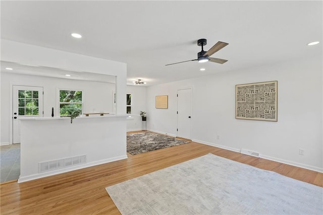 8918 Switzer St, Overland Park, KS 66214 - unfurnished living room with a ceiling fan, recessed lighting, and light wood-style flooring