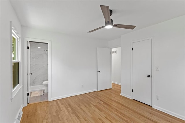 8918 Switzer St, Overland Park, KS 66214 - unfurnished bedroom with light wood-style flooring, ensuite bathroom, and a ceiling fan