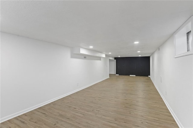 8918 Switzer St, Overland Park, KS 66214 - finished basement featuring light wood-style flooring and recessed lighting