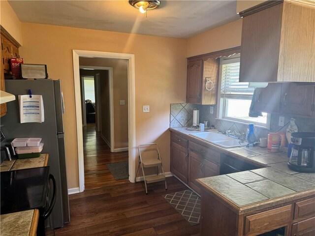 106 Northview Dr, Excelsior Springs, MO 64024 - kitchen featuring dark wood-style floors, tile countertops, tasteful backsplash, and stove