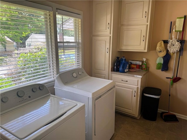 106 Northview Dr, Excelsior Springs, MO 64024 - washroom with cabinet space, washing machine and clothes dryer, and dark tile patterned flooring
