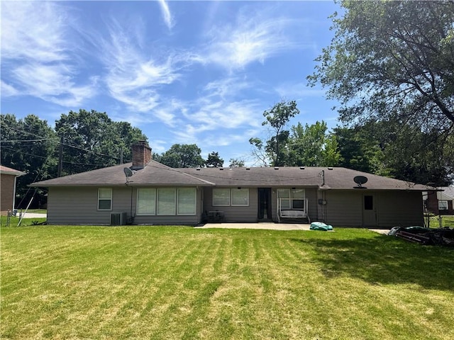 106 Northview Dr, Excelsior Springs, MO 64024 - rear view of house featuring a yard, a patio area, and a chimney