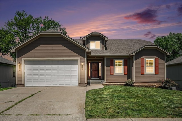 19208 E Lynchburg Pl, Independence, MO 64058 - view of front facade with concrete driveway, a yard, an attached garage, and a shingled roof