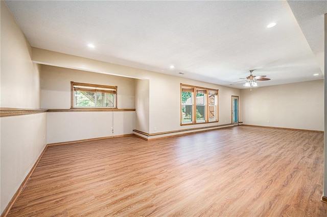 19208 E Lynchburg Pl, Independence, MO 64058 - unfurnished room with light wood-type flooring, ceiling fan, recessed lighting, and a baseboard heating unit