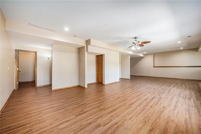 19208 E Lynchburg Pl, Independence, MO 64058 - empty room featuring light wood-style floors, ceiling fan, and recessed lighting