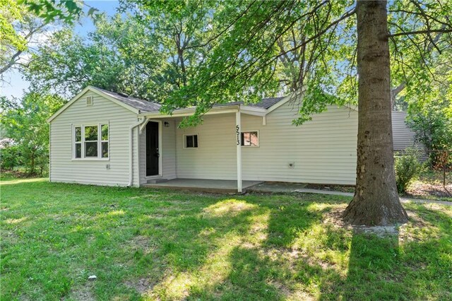 5513 Hardy Ave, Raytown, MO 64133 - rear view of house featuring a yard and a patio area