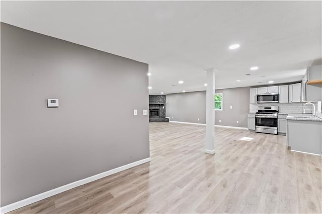 5513 Hardy Ave, Raytown, MO 64133 - kitchen with stainless steel appliances, recessed lighting, tasteful backsplash, and light wood-type flooring