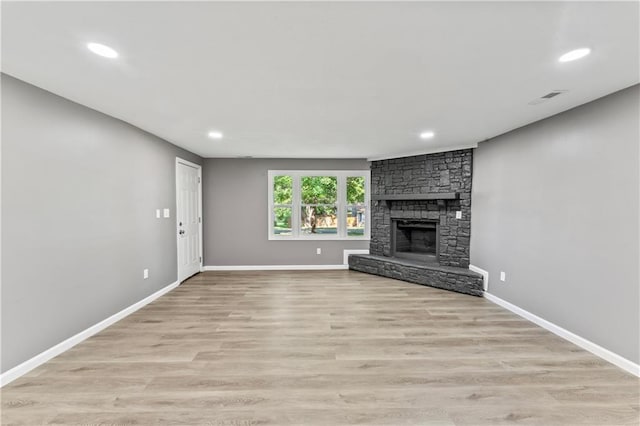 5513 Hardy Ave, Raytown, MO 64133 - unfurnished living room featuring recessed lighting, a fireplace, and light wood finished floors