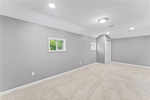 5513 Hardy Ave, Raytown, MO 64133 - below grade area featuring light carpet, recessed lighting, and a textured ceiling