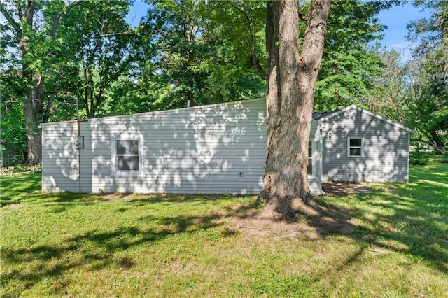 5513 Hardy Ave, Raytown, MO 64133 - view of side of home with a lawn and an outbuilding