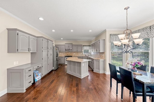 11927 W 131st Ter, Overland Park, KS 66213 - kitchen featuring stainless steel appliances, gray cabinets, a chandelier, dark wood-type flooring, and ornamental molding