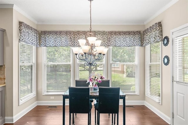 11927 W 131st Ter, Overland Park, KS 66213 - dining space featuring a chandelier, dark wood-type flooring, and crown molding
