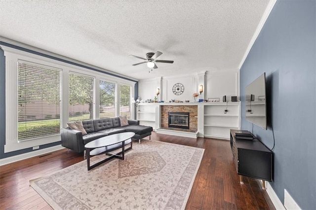 11927 W 131st Ter, Overland Park, KS 66213 - living area with a ceiling fan, a textured ceiling, dark wood finished floors, ornamental molding, and a fireplace