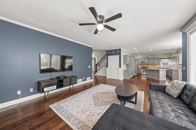 11927 W 131st Ter, Overland Park, KS 66213 - living room with stairway, ceiling fan, dark wood finished floors, ornamental molding, and recessed lighting