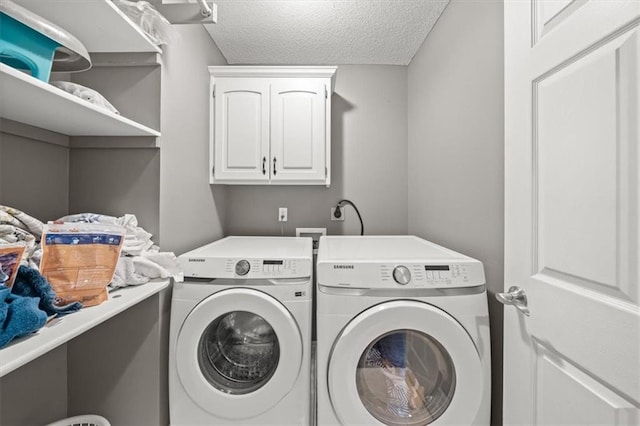 11927 W 131st Ter, Overland Park, KS 66213 - laundry area featuring washing machine and clothes dryer, a textured ceiling, and cabinet space