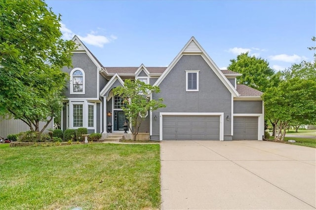 11927 W 131st Ter, Overland Park, KS 66213 - view of front of home featuring a front lawn, concrete driveway, stucco siding, and a garage