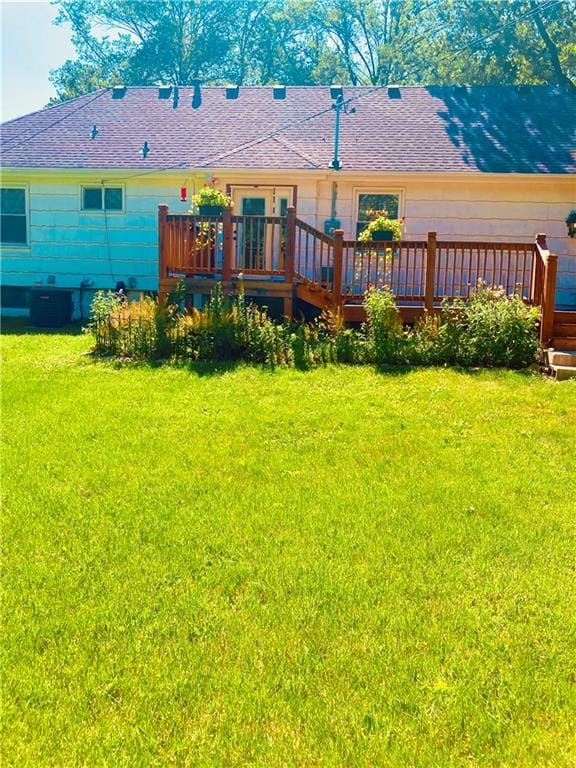 7909 Appleton Ave, Raytown, MO 64138 - back of property featuring a wooden deck, a yard, and roof with shingles