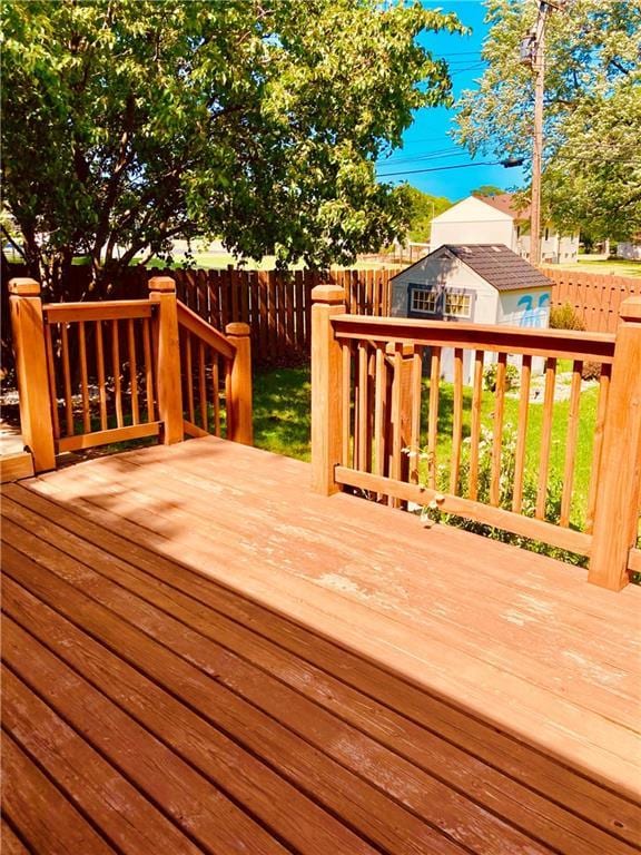 7909 Appleton Ave, Raytown, MO 64138 - wooden deck with a fenced backyard and an outdoor structure