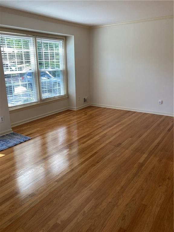 7909 Appleton Ave, Raytown, MO 64138 - spare room featuring ornamental molding and wood finished floors