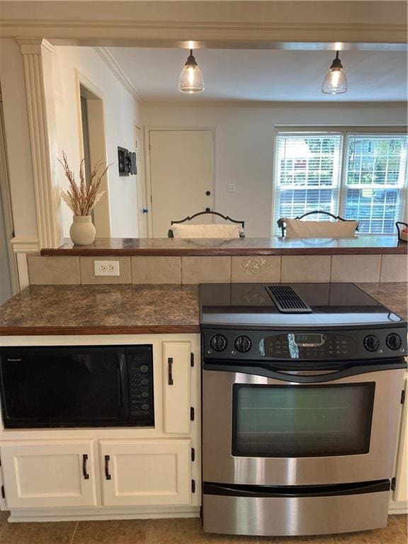 7909 Appleton Ave, Raytown, MO 64138 - kitchen with stainless steel electric range oven, black microwave, white cabinets, and ornamental molding
