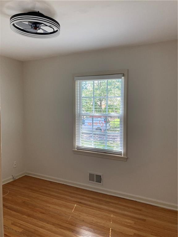 7909 Appleton Ave, Raytown, MO 64138 - spare room featuring light wood finished floors and baseboards