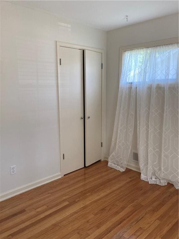 7909 Appleton Ave, Raytown, MO 64138 - unfurnished bedroom with light wood-style flooring and a closet
