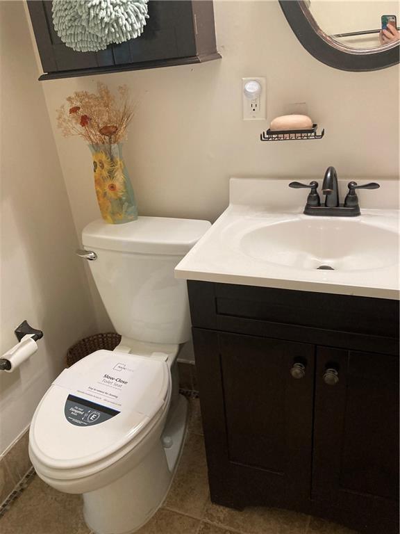 7909 Appleton Ave, Raytown, MO 64138 - bathroom with vanity and tile patterned floors