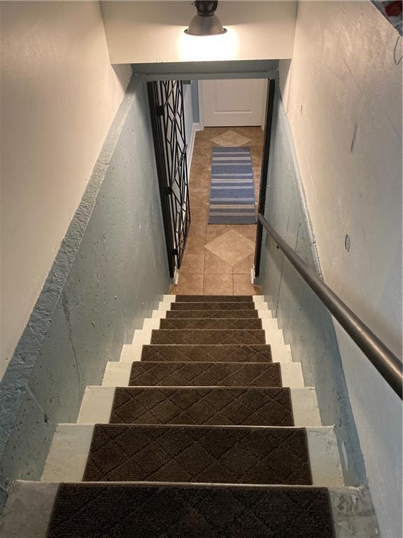 7909 Appleton Ave, Raytown, MO 64138 - stairs featuring tile patterned floors