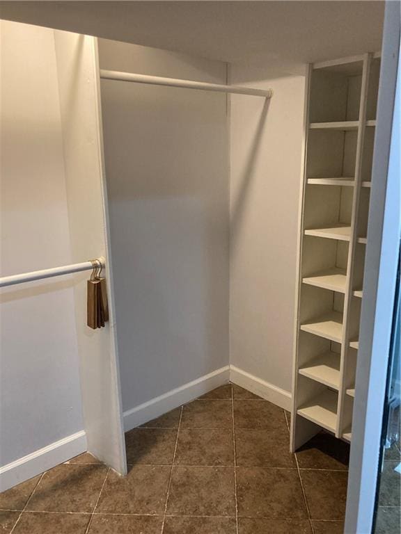7909 Appleton Ave, Raytown, MO 64138 - walk in closet featuring dark tile patterned floors