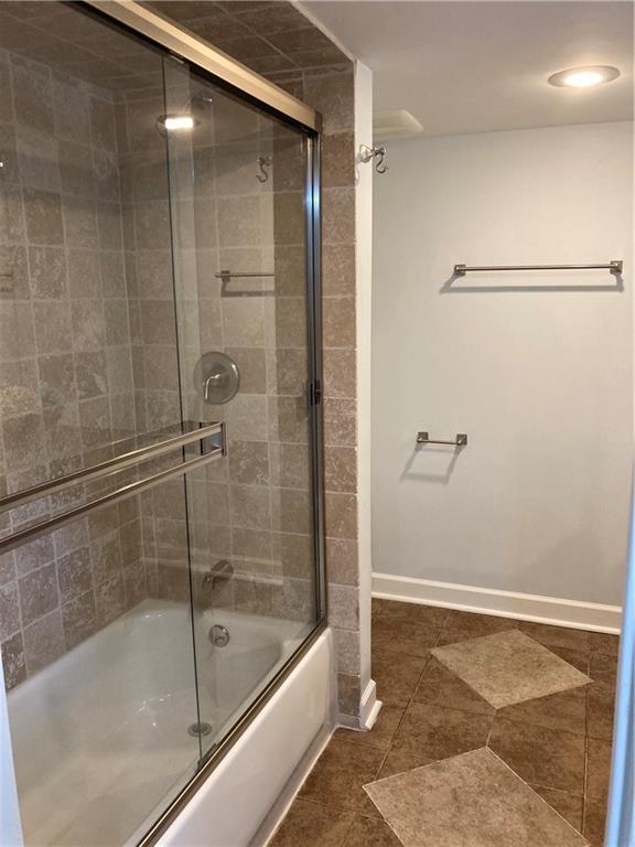7909 Appleton Ave, Raytown, MO 64138 - full bathroom with bath / shower combo with glass door and tile patterned floors