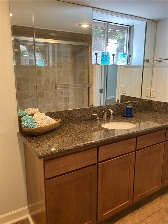 7909 Appleton Ave, Raytown, MO 64138 - bathroom with vanity, tile patterned floors, and a stall shower