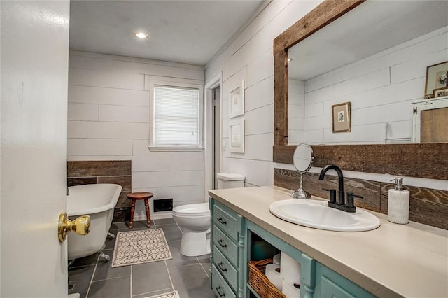 12508 Valley Brook Dr, Grandview, MO 64030 - full bathroom featuring a freestanding bath, tile patterned floors, vanity, and tile walls