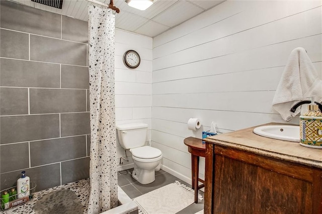 12508 Valley Brook Dr, Grandview, MO 64030 - full bathroom featuring tiled shower, vanity, tile patterned floors, and wood walls