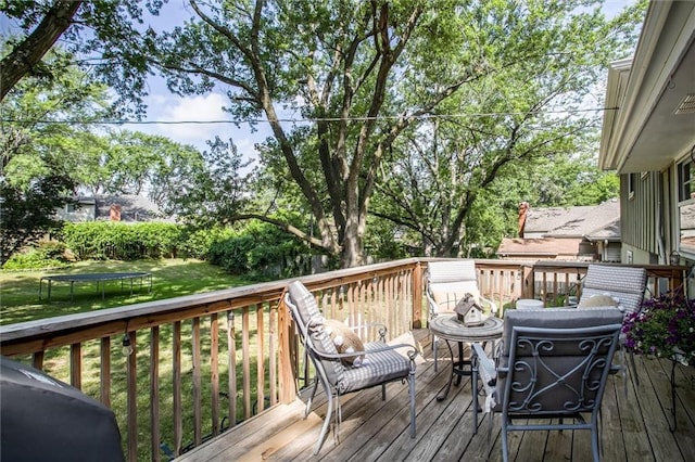 12508 Valley Brook Dr, Grandview, MO 64030 - deck featuring a trampoline and a lawn